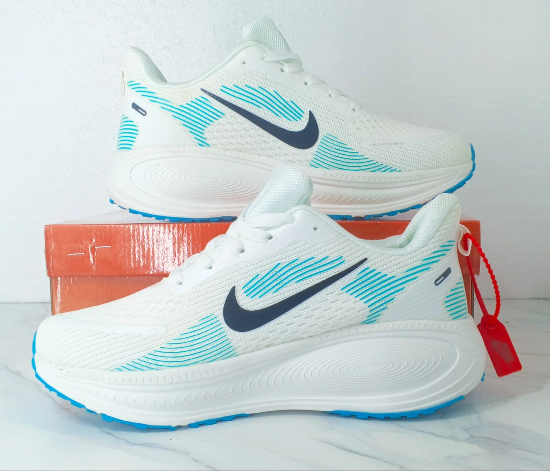 Nike Vomero 18 Zoomx White, with accents of Light Blue