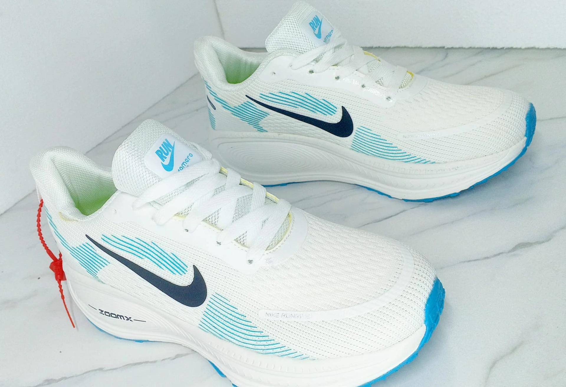 Nike Vomero 18 Zoomx White, with accents of Light Blue