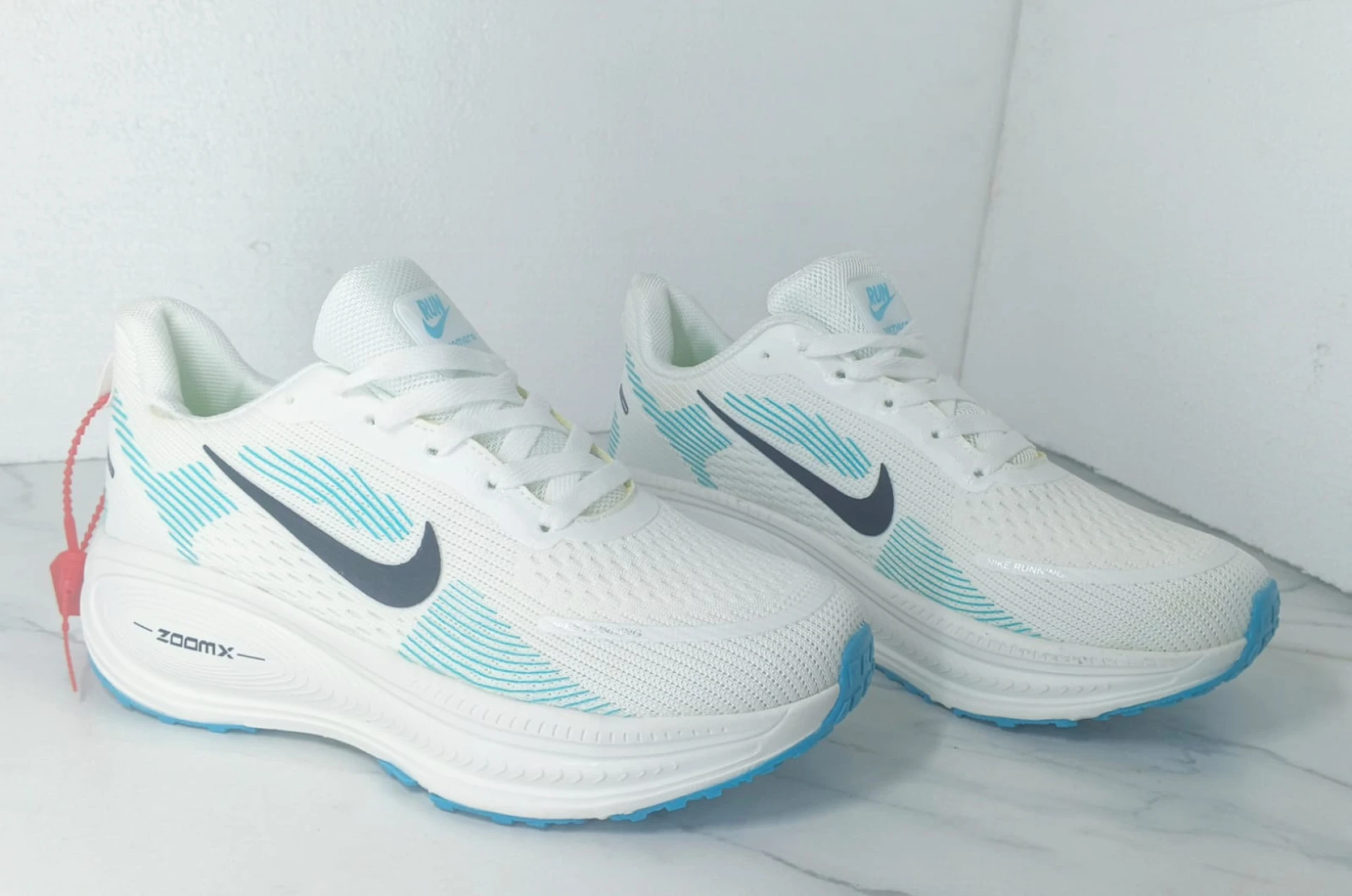 Nike Vomero 18 Zoomx White, with accents of Light Blue